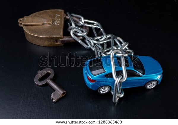 Securing the car against theft.\
Protection against theft of a passenger car. Dark\
background.