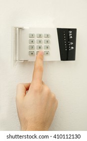 Security Alarm Keypad With Male Hand, Closeup