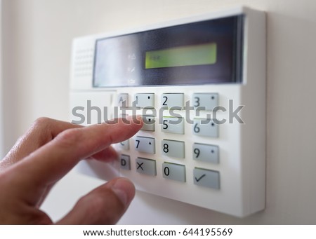 Security alarm keypad with person arming the system concept for crime prevention