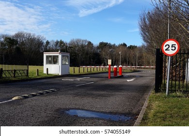 Security Barrier, Speed Limit Sign And Guard Hut At Entrance To Office Parking Lot