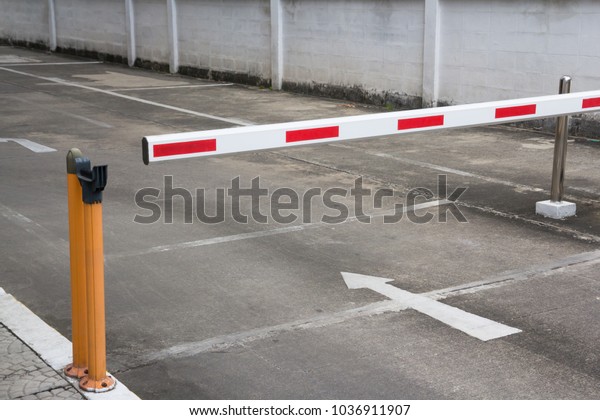 security barrier system\
at the gate of car park background, red and white steel Rising Arm\
Access Barrier