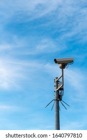 Security camera before blue sky