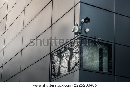Security camera or CCTV is outsite on the wall of the modern building. Video equipment for safety system area control outdoor, The concept of Professional surveillance, Selective focus.