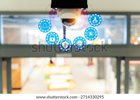 Security camera with digital interface icons showing surveillance, monitoring, alerts, and protection inside a modern building, representing smart technology, safety systems, and business security.