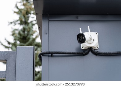 A security camera has been strategically mounted on the side of a building for enhanced monitoring and surveillance purposes