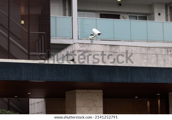 Security camera installed at the entrance of an\
apartment house