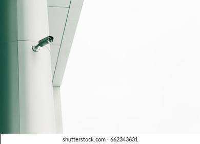 Security camera mounted on the facade of the modern building. toned. copy space.