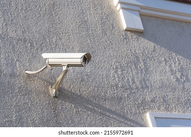 a security camera mounted on the wall of a private house