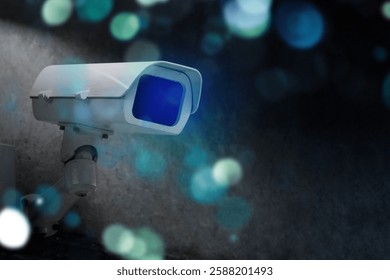 Security camera mounted on a wall, capturing surveillance footage. Surveillance camera in focus, with a blurred background. Security and surveillance theme. Security and protection image.