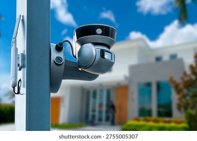 Security camera mounted outside of a building during a sunny day in an urban setting