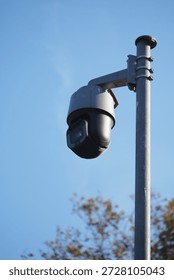 Security camera on pole under blue sky