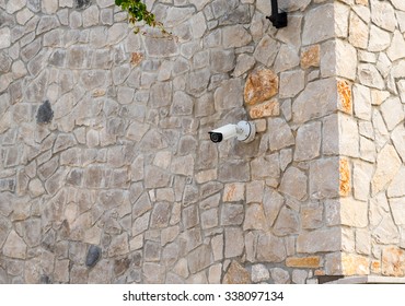 security camera on a stone wall