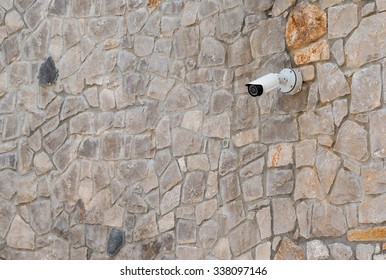 security camera on a stone wall
