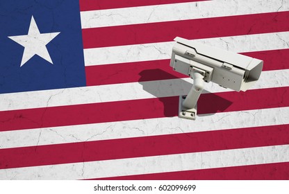 Security camera on wall with painted Liberia flag background. Concept political relations with neighbors