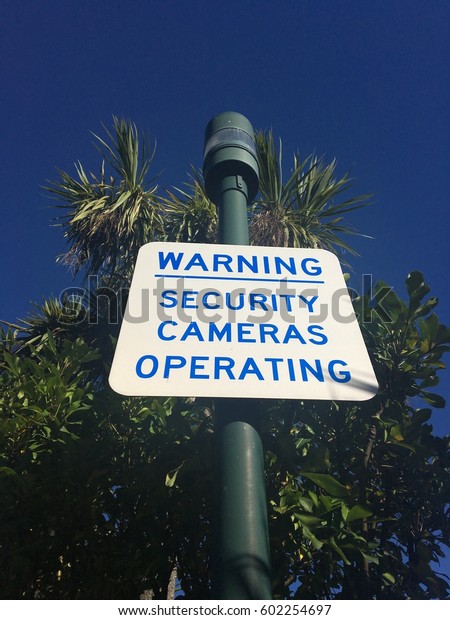 Security camera road\
sign