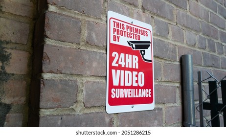 Security camera sign on wall