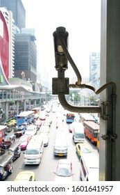 A security camera watching over jammed traffic. Blurred and bright background.