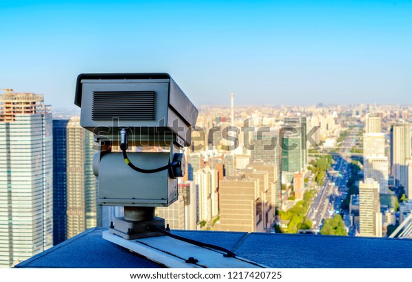 The security cameras on a balcony high\
building.Used to view road\
traffic.