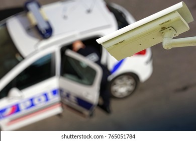 Security CCTV Camera Or Surveillance System With Police Car On Blurry Background