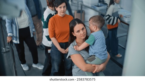 Security Checkpoint in Airport Terminal: Queue of Diverse People, Tourists Standing for Metal Detector Scanning Gates. Passengers During TSA Screening Procedures for Boarding Plane Flight. High Angle.