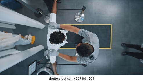 Security Checkpoint, TSA Screening Procedures: Diverse People Passing Through X-ray Metal Detector Scanner, African American Airport Worker Checking Passengers. Crowd of Travelers in Airport. Top View
