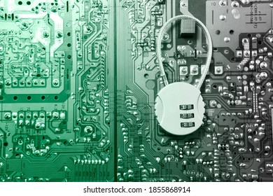 Security cipher padlock on computer circuit board.