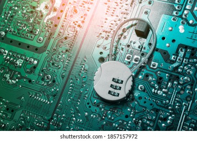 Security cipher padlock on computer circuit board.