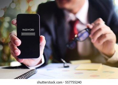 Security Concept. Businessman Hand Holding A Touch Phone With Password On The Screen 