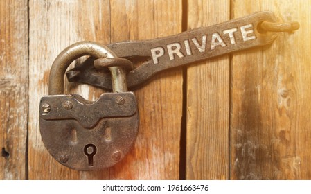Security concept. There is a lock on the door on the metal part of which it is written - PRIVATE