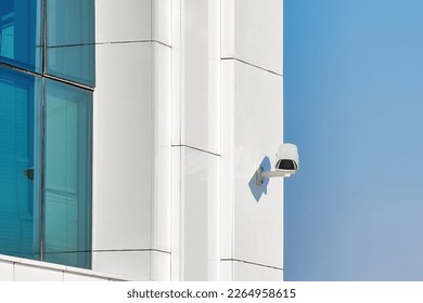 Security control camera or CCTV on a white wall.