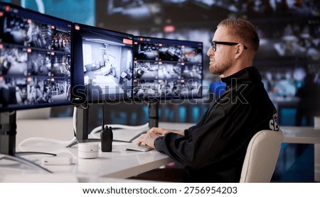 Security Control Room Operator Observes Multiple CCTV Screens For Video Monitoring And Safety Management