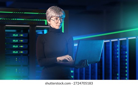 IT security, cybersecurity analyst manages server networks with a laptop to protect data and maintain reliable digital infrastructure inside a data center.