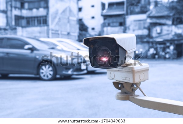 Security equipment concept - CCTV camera\
surveillance on car parking Safety system area control with flare\
light and copy space.
