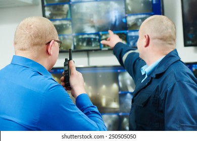 Security Executive Chief Discussing Activity With Worker In Front Of Video Monitoring Surveillance Security System