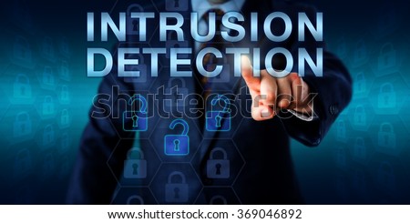 Security expert is pushing INTRUSION DETECTION on a touch screen interface. Three opened lock icons among otherwise locked virtual padlocks are highlighted. Technology and business concept.
