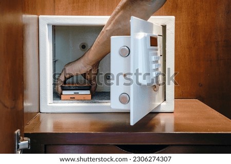 Security external hard drive in open metal safe. External hard disk containing confidential and important information keep well in white safe box. Confidentiality and Importance of Information Concept