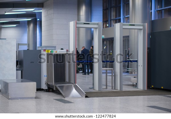 Security gates with metal detectors and scanners\
at entrance of airport