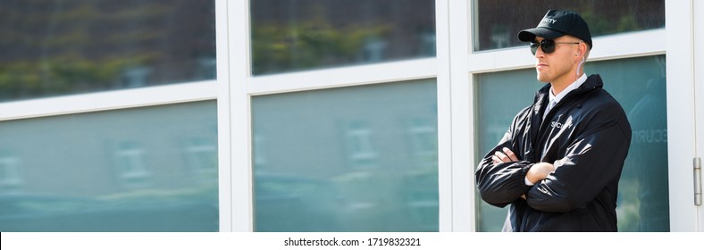 Security Guard Agent Standing At Door Entrance