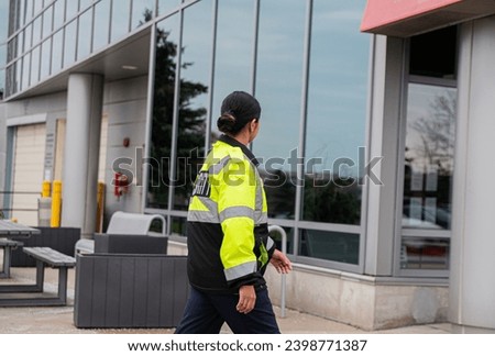 Security guard conducting access control and traffic control around a community building.