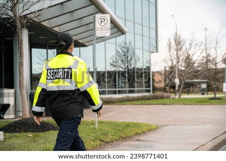 Security guard conducting access control and traffic control around a community building.