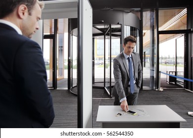 Security Guard Controlling Indoor Entrance Gate