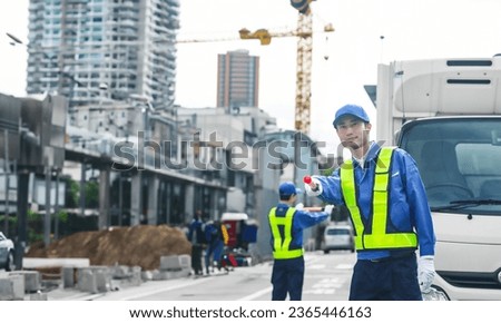 Security guard controlling traffic at a construction site.