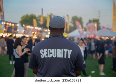 Security guard controlling the traffic and parking at Asian festival in Canada