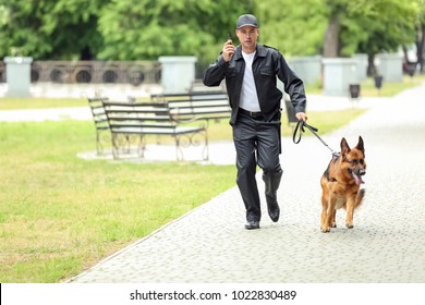 Security Guard With Dog In Park