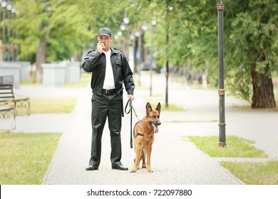 Security Guard With Dog In Park