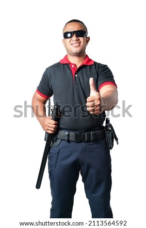 A security guard dressed in black, wearing dark glasses, stands looking straight and thumbs up. And there are rubber batons on the tactical belt. white background isolated, cut out. Security concept