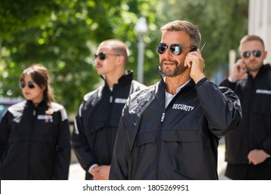 Security Guard Event Service. Officer And His Group - Powered by Shutterstock