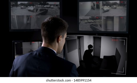 Security Guard In Front CCTV Footage Watching Bank Robbery, Safety And Guarding