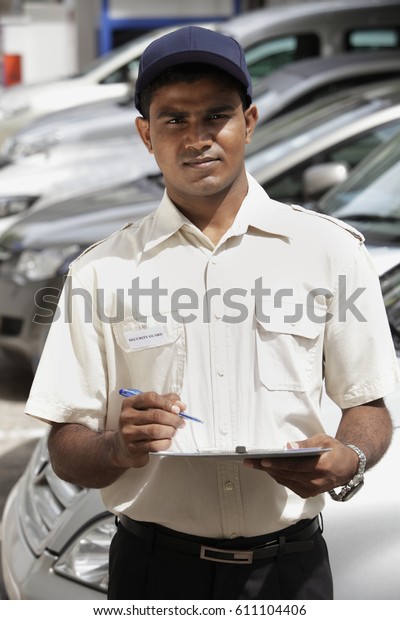 Security guard holding\
clipboard