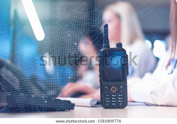 Security guard
monitoring modern CCTV cameras in surveillance room. Female
security guard in surveillance room. Female security guard holding
portable radio in hand at
workplace.